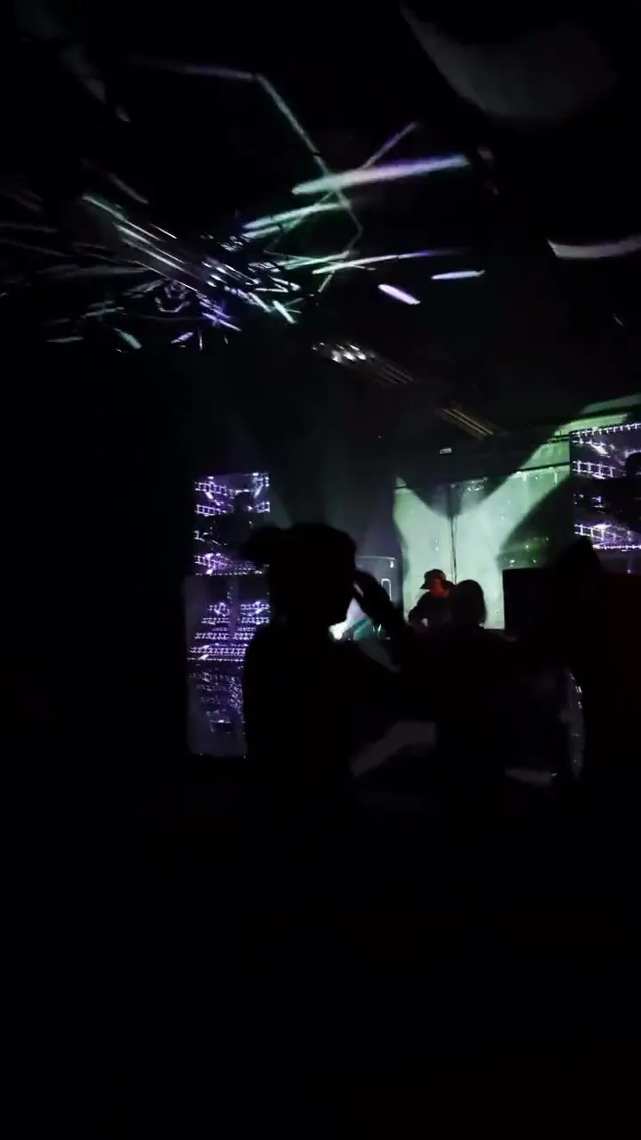 Light structures and projection beams on stage during a club night mapped with LayerMapper.