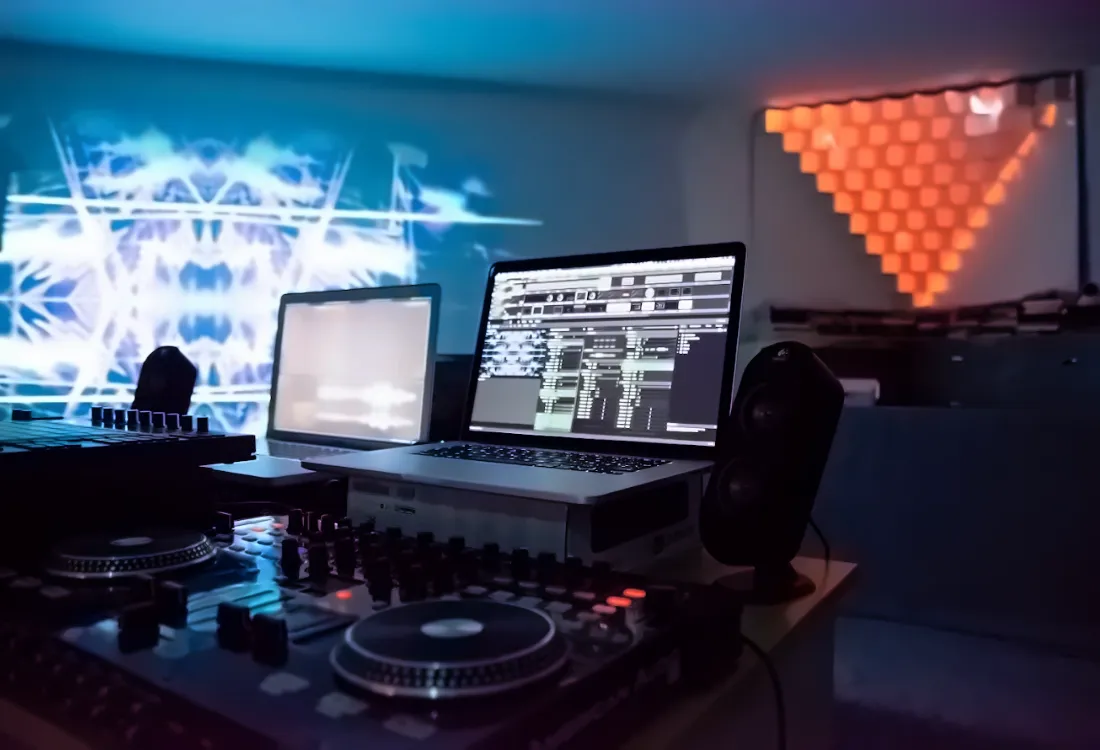Home studio with DJ decks, monitors and a hexagon light panel