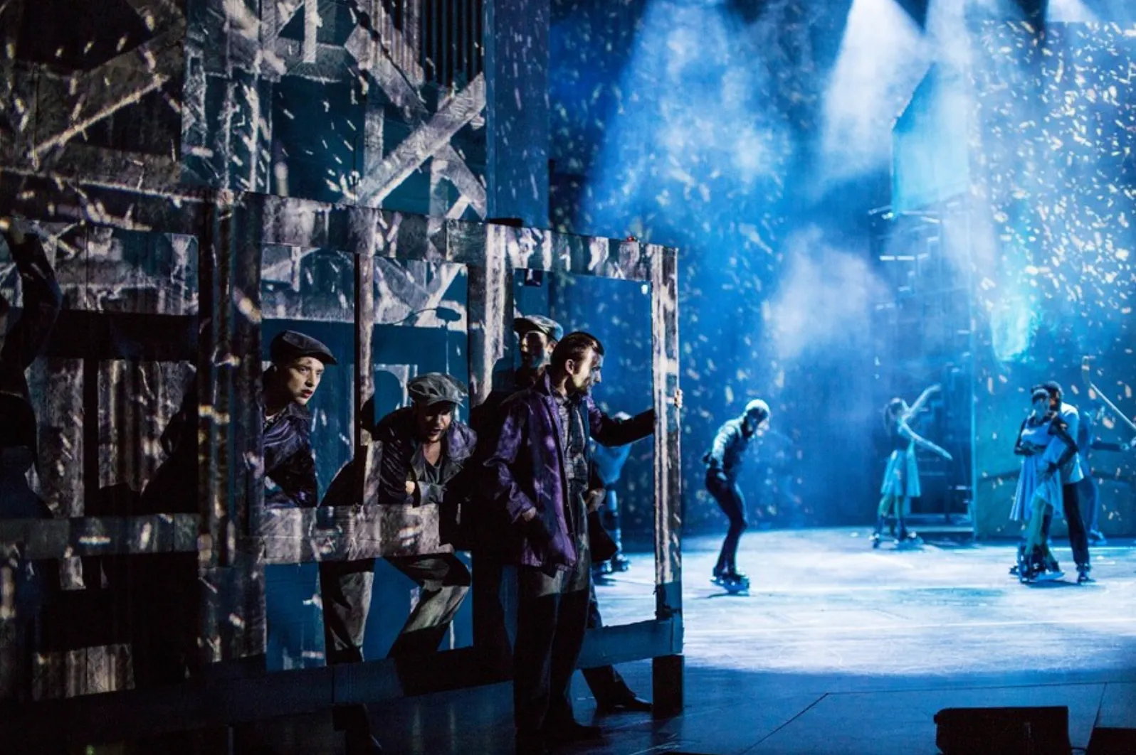 Theatre stage with blue projected scenery and snow